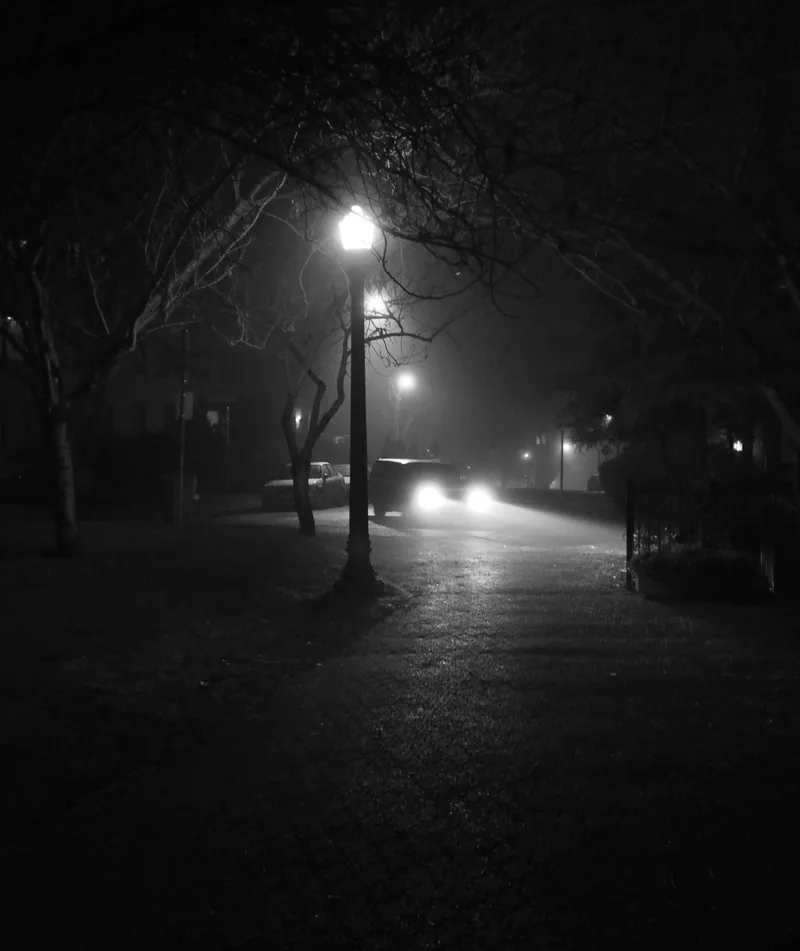 Car lights on a foggy night in downtown Vancouver